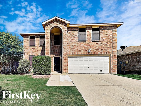 a brick house with a white garage door
