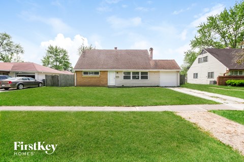 A house with a brown roof and a white garage door is for sale.