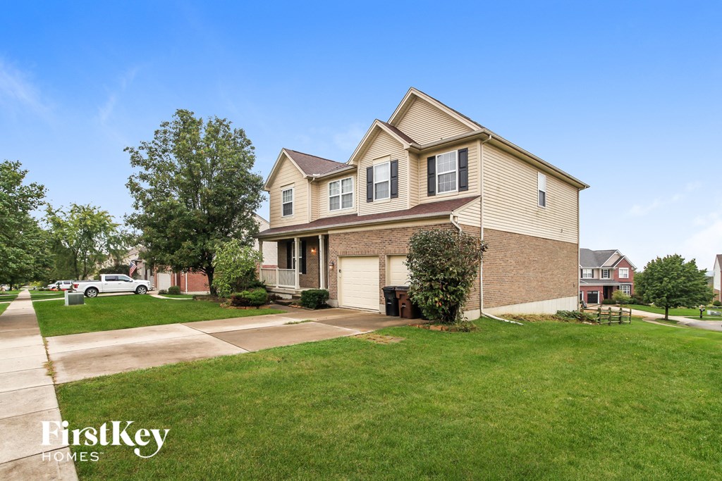 a suburban house with a lawn and a driveway