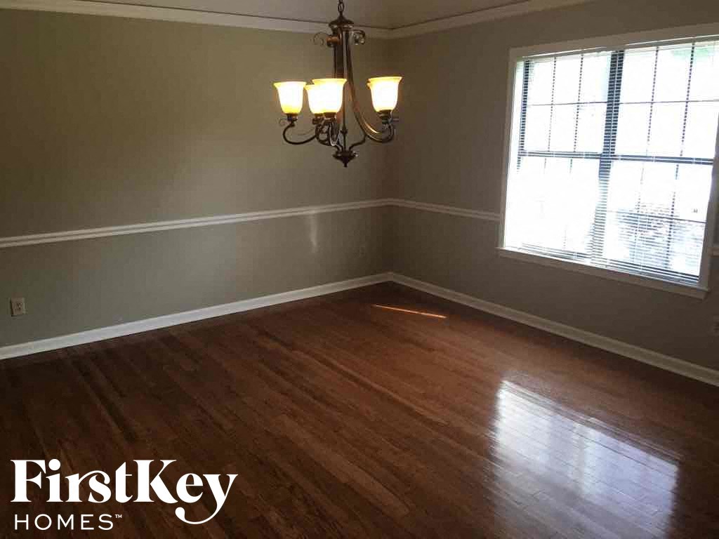 A room with wooden floors and a chandelier.