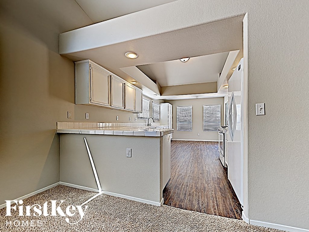 A kitchen area with a counter and cabinets.