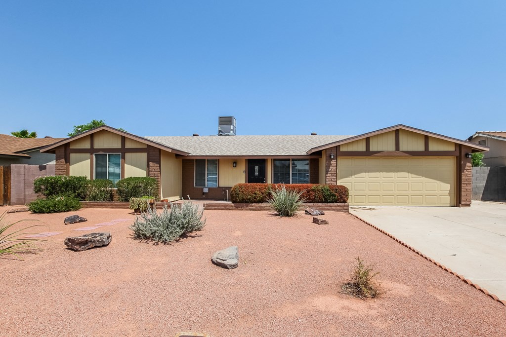 A house with a brown roof and a garage door.