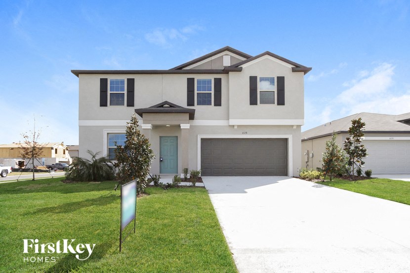 A two-story house with a garage is for sale by FirstKey Homes.