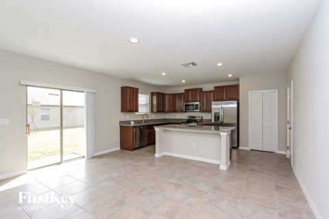A kitchen with white cabinets and a white island.