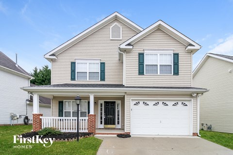 A two-story house with a garage is for sale.