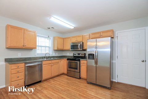 A kitchen with wooden cabinets and stainless steel appliances.