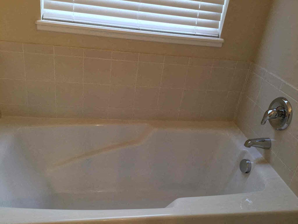 a bath tub in a bathroom with a window