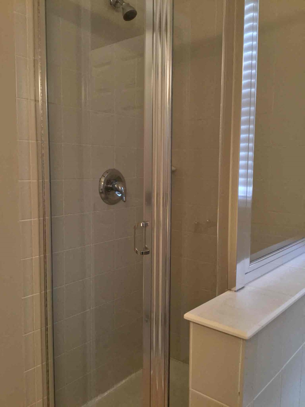 a bathroom with a shower and a sink