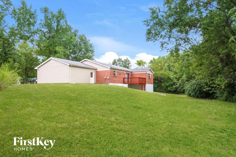 a house on a hill with a grassy yard