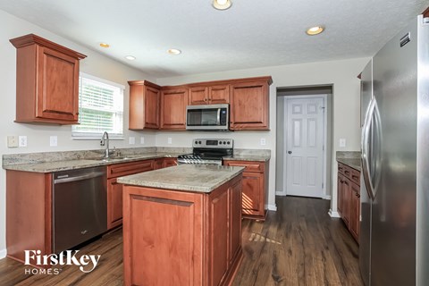 a kitchen with wooden cabinets and stainless steel appliances