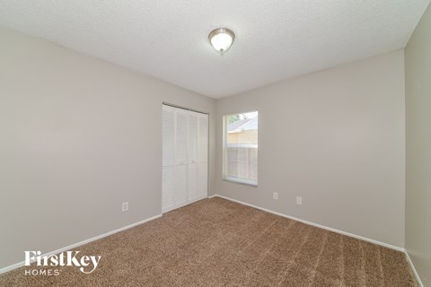 a spacious living room with carpet and a large window