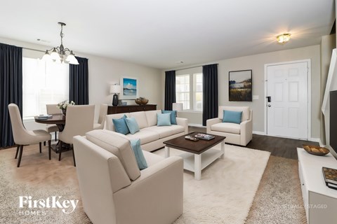 A living room with a white couch and a coffee table.