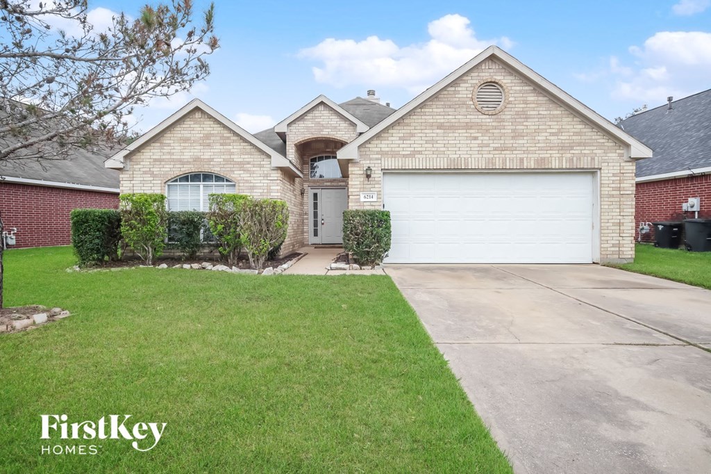 a home with a white garage door and a lawn
