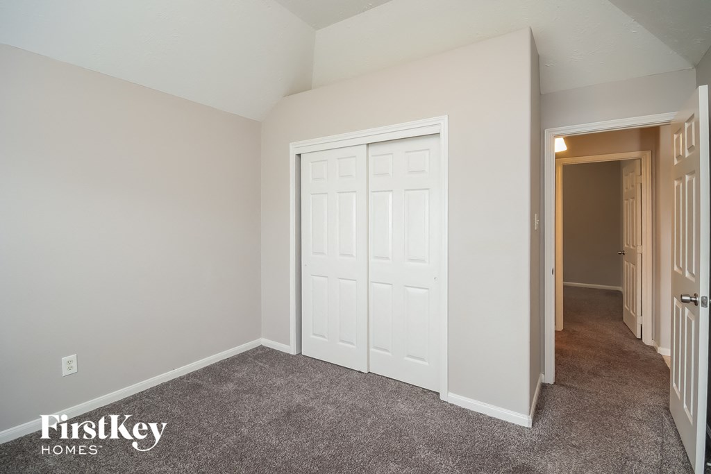 a bedroom with two closets and a door to a hallway