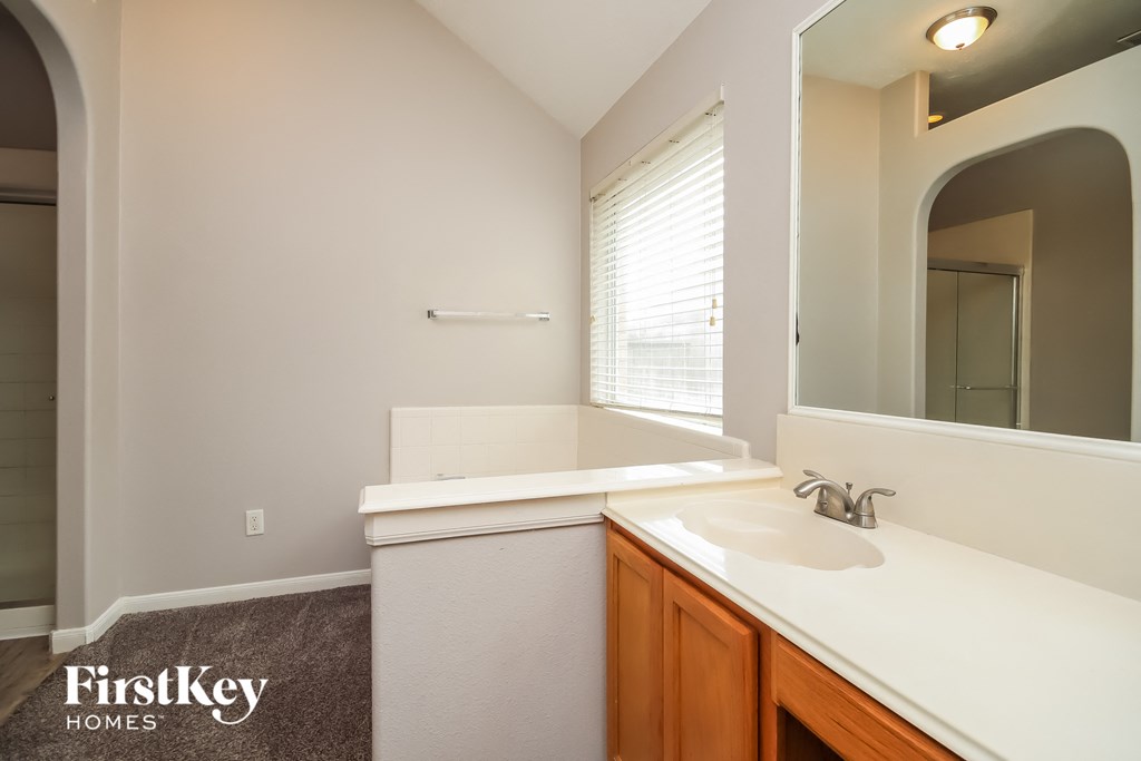 an empty bathroom with a sink and a mirror