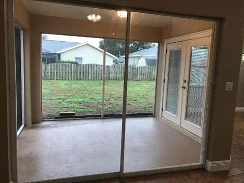 a living room with a sliding glass door and a yard