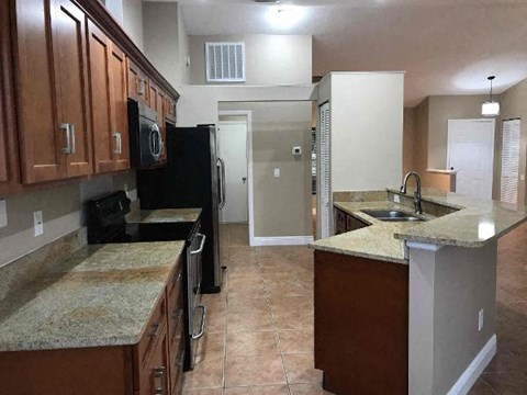 a kitchen with a sink and a refrigerator