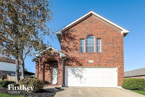 a brick house with a white garage door