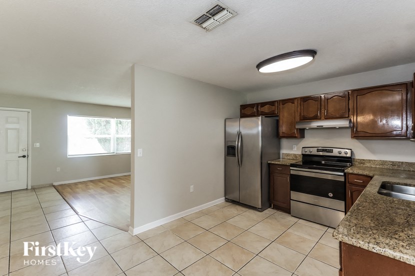 a kitchen with stainless steel appliances and tile flooring