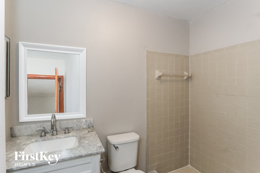 a bathroom with a toilet and a sink and a shower