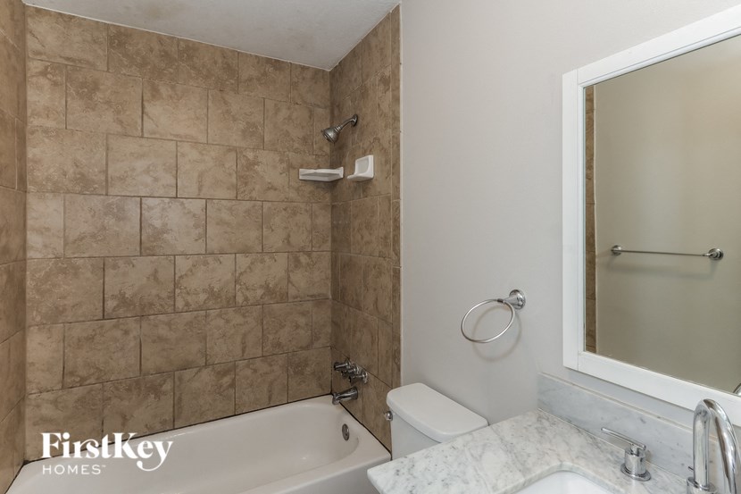 a bathroom with a tub and a toilet and a sink