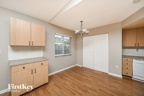 a kitchen with wooden floors and wooden cabinets