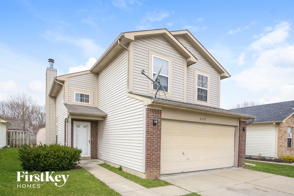 A house with a garage and a driveway is for sale.