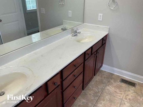 a bathroom with a vanity with two sinks and a mirror