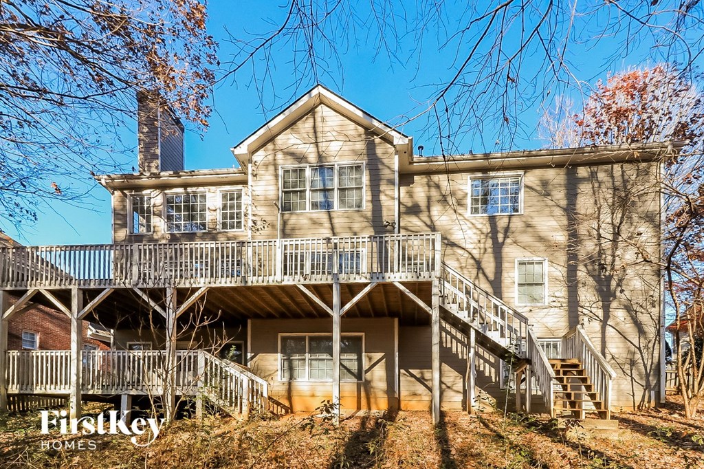 the front of a house with two decks and stairs