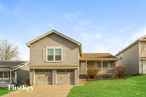 A house with a brown roof and a garage door is shown.
