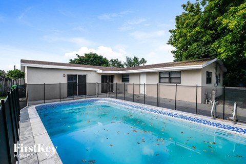 a pool with a house in the background