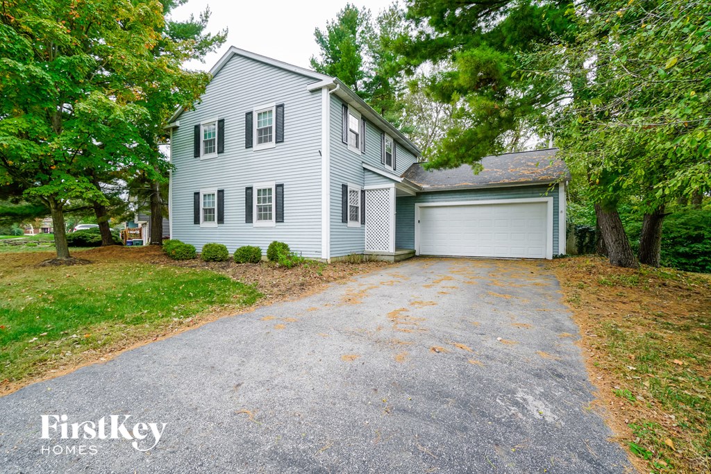 a white house with a driveway and a white garage door