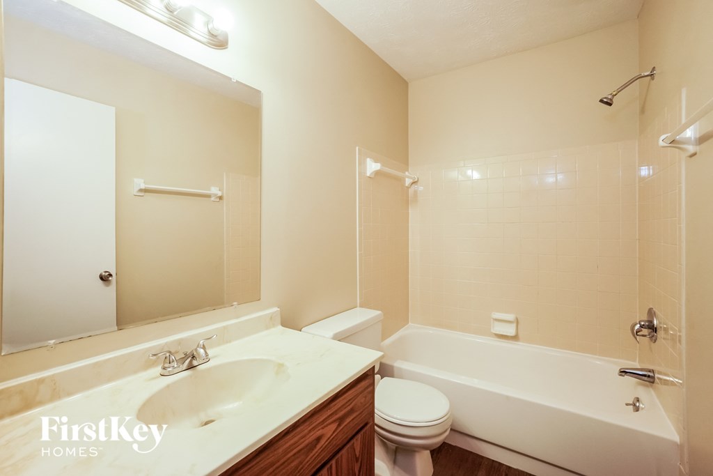 a bathroom with a sink toilet and a bath tub