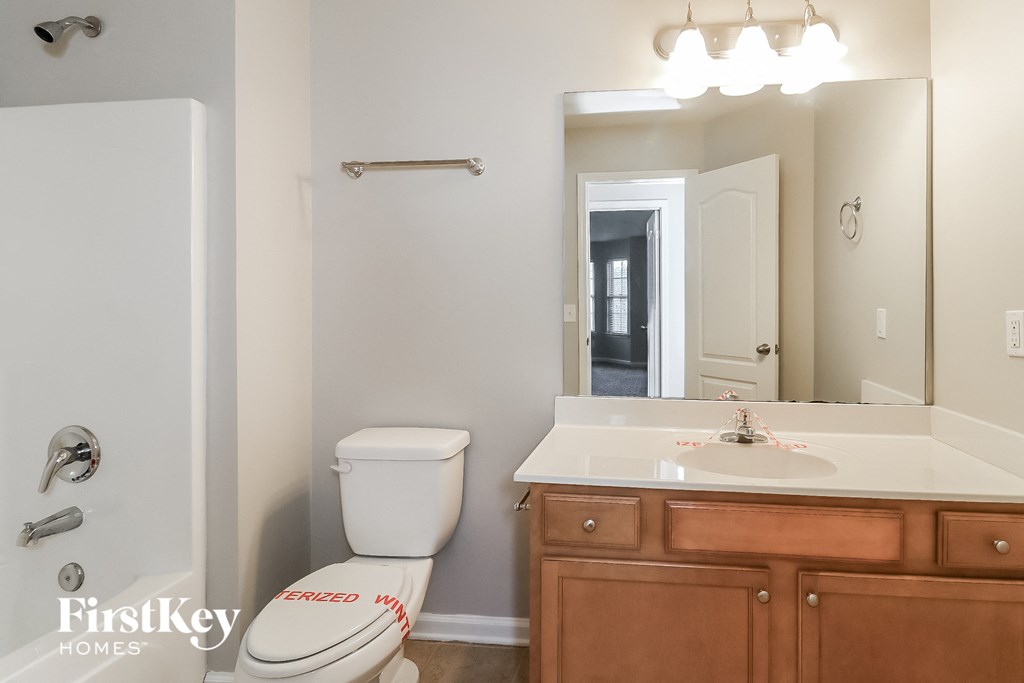 a bathroom with a toilet and a sink and a mirror