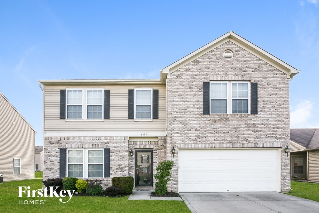 a brick house with a white garage door