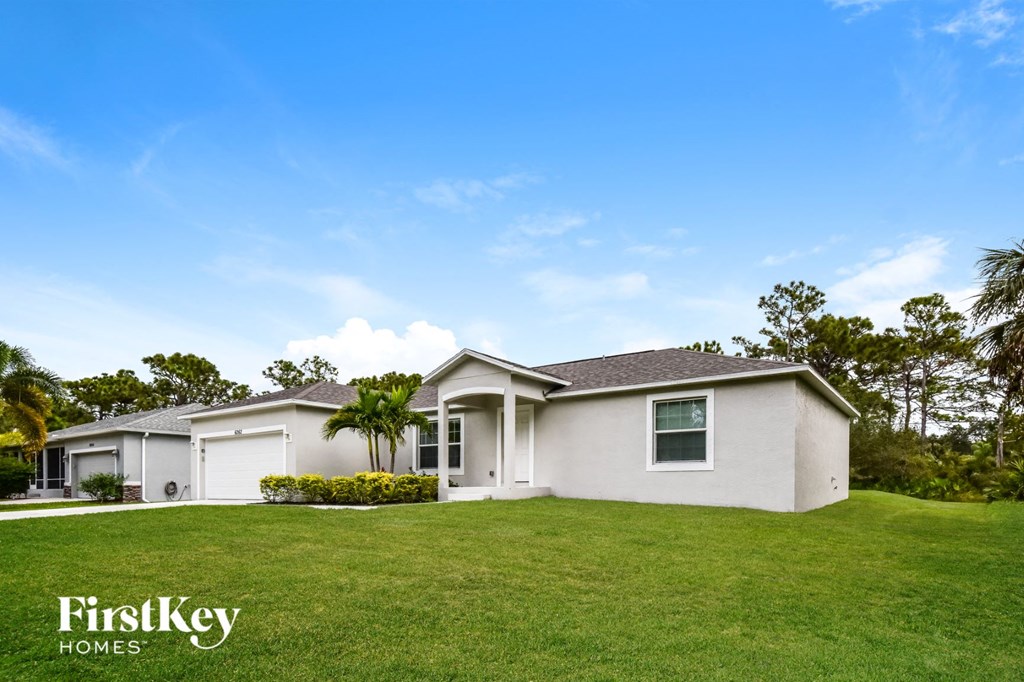 A house with a lawn in front of it and the words "FirstKey Homes" on the bottom left.