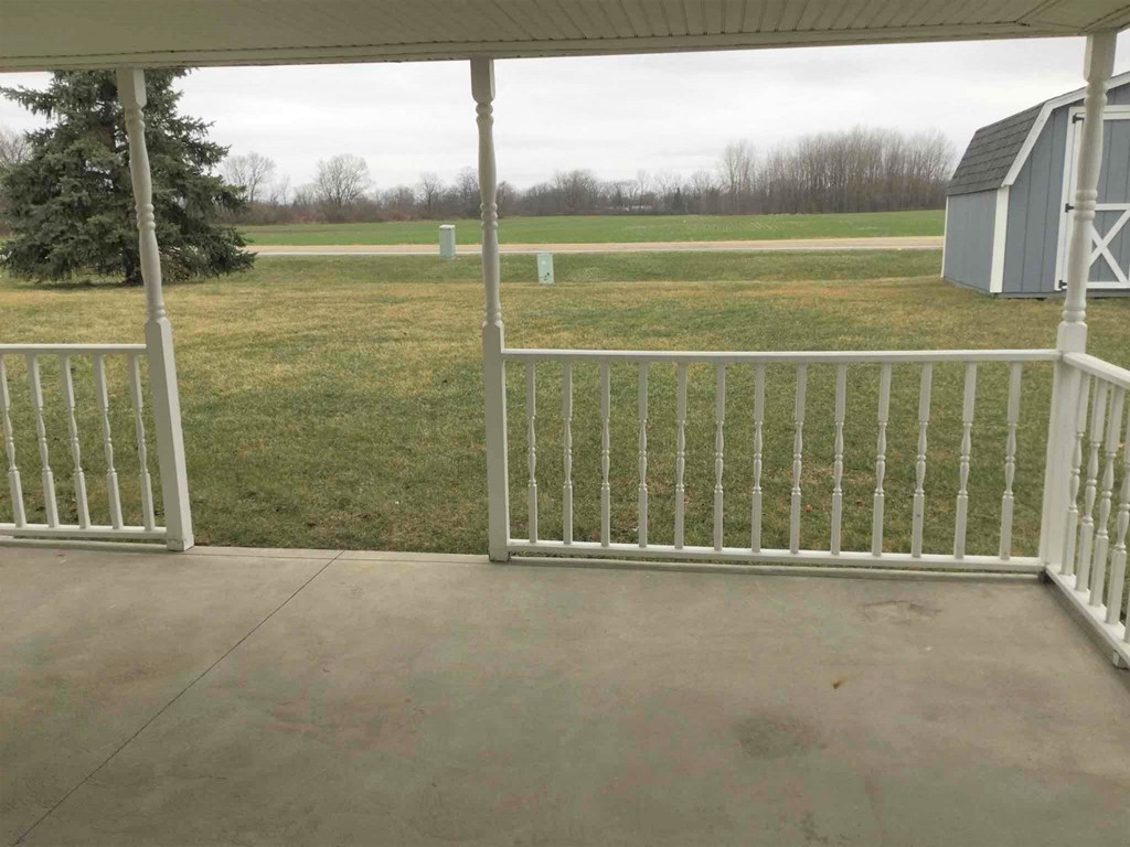a view of a yard from the porch of a house