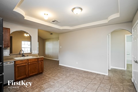 A kitchen with a sink and a refrigerator.