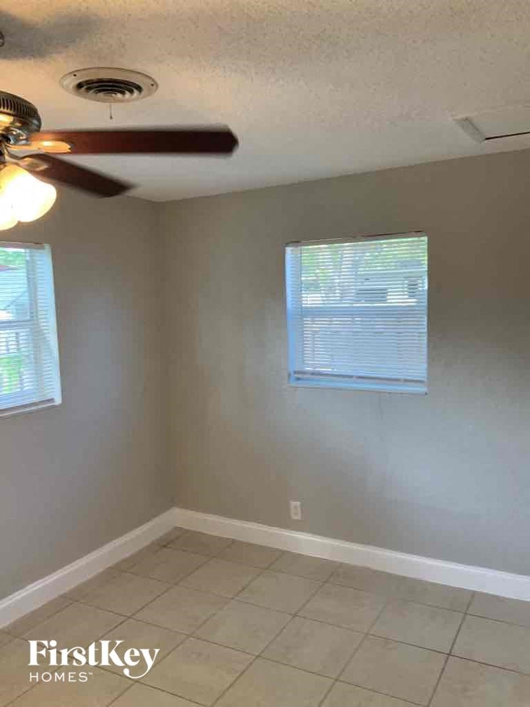 a corner of a room with a ceiling fan