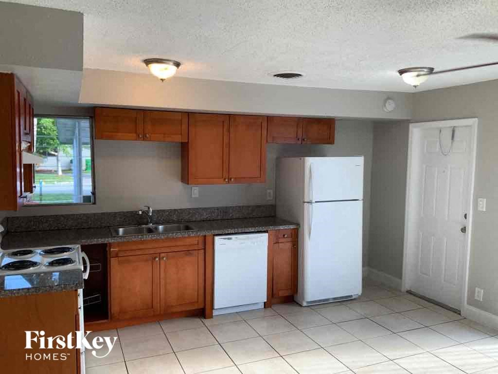 a kitchen with wooden cabinets and a white refrigerator