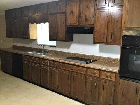 a kitchen with wooden cabinets and a counter top