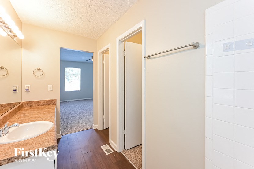 a bathroom with a shower and a sink and a mirror