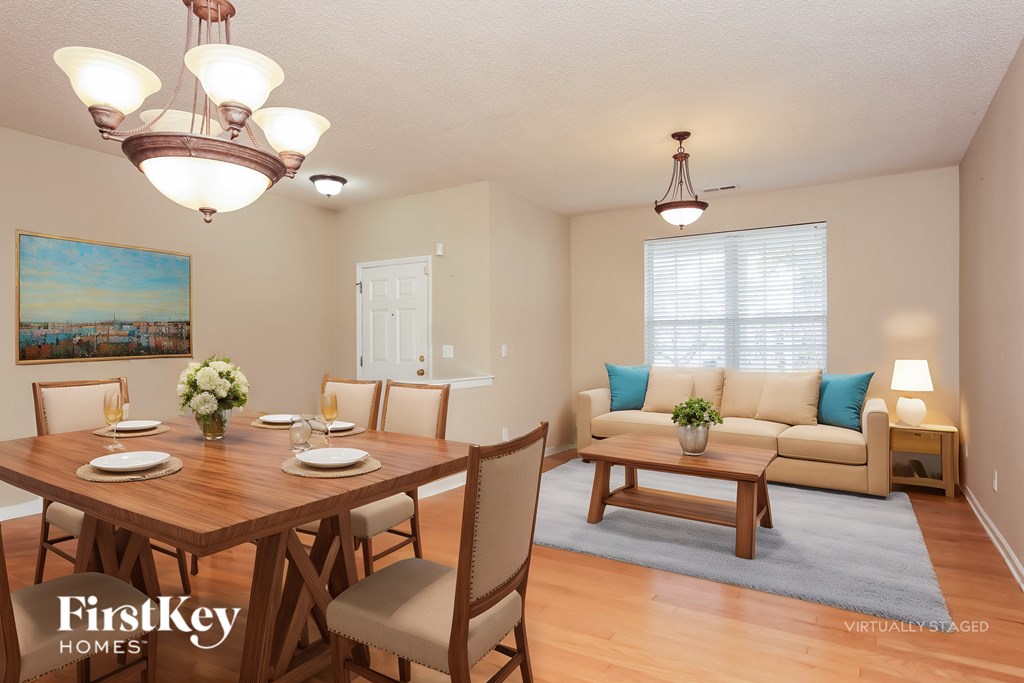 A dining room with a wooden table set for four.