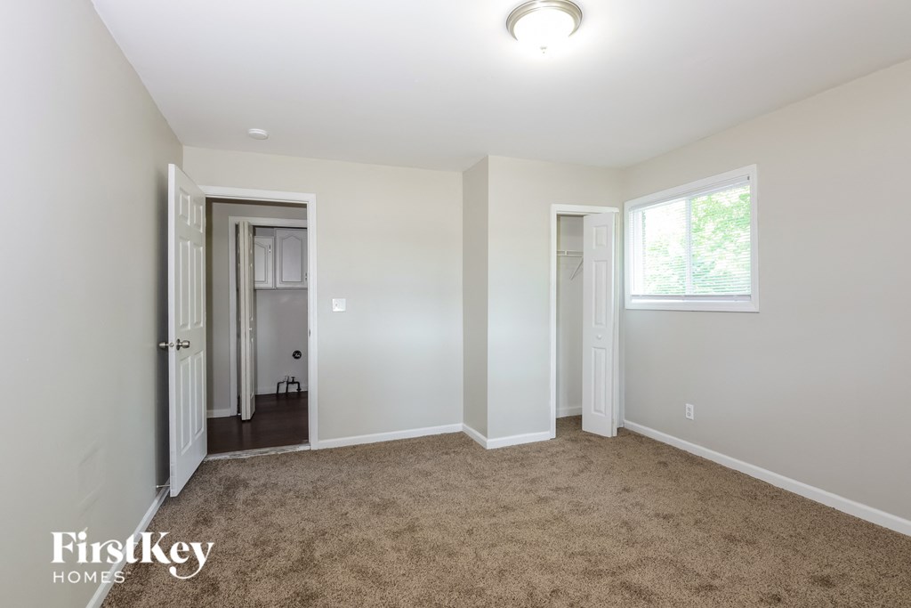 a bedroom with a carpeted floor and white walls