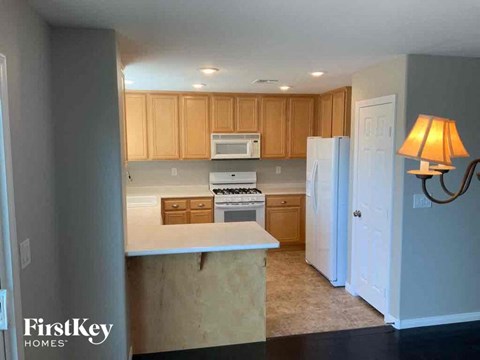 A kitchen with wooden cabinets and a white countertop.