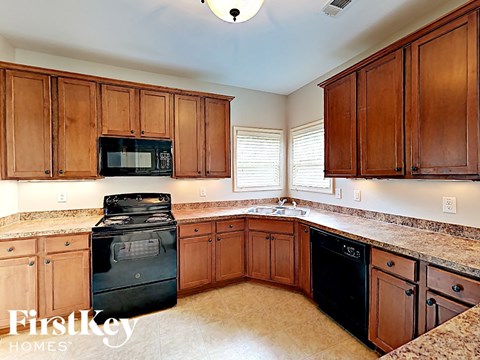 a kitchen with wooden cabinets and black appliances