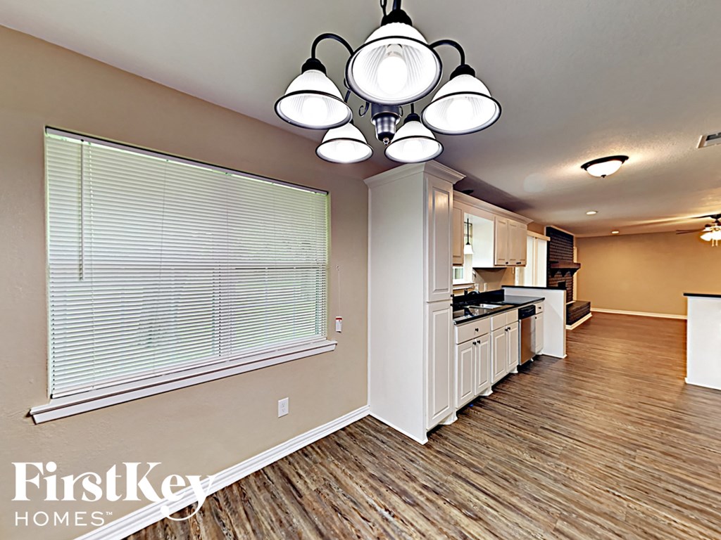 an empty kitchen with a large window and a window sill