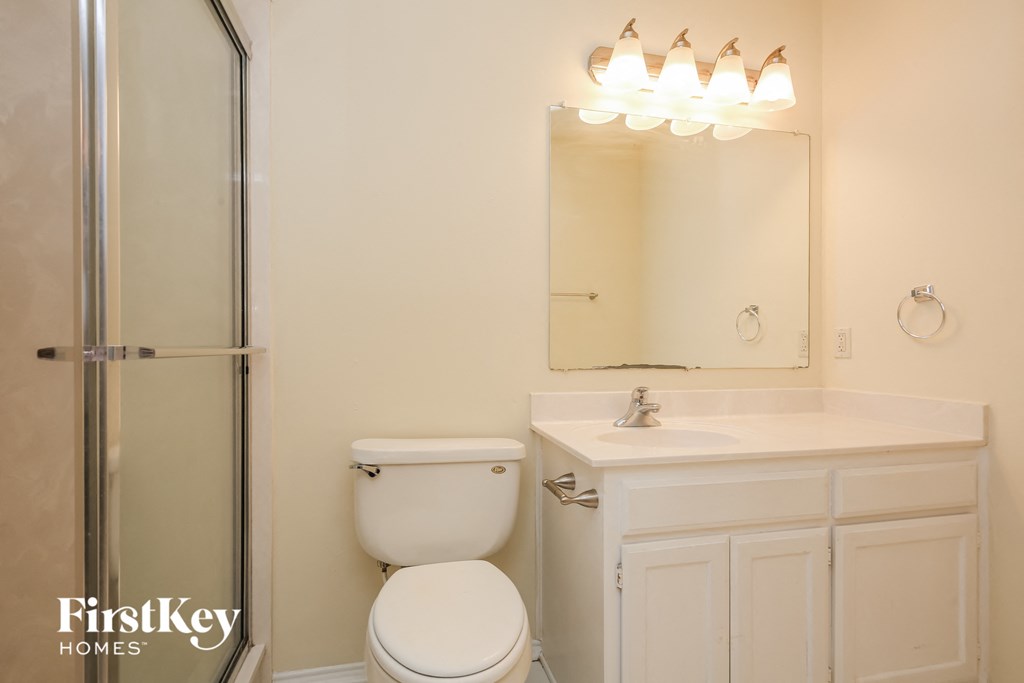 a bathroom with a sink toilet and a shower