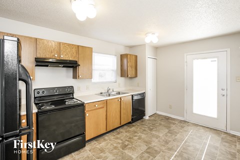 a kitchen with black appliances and wooden cabinets