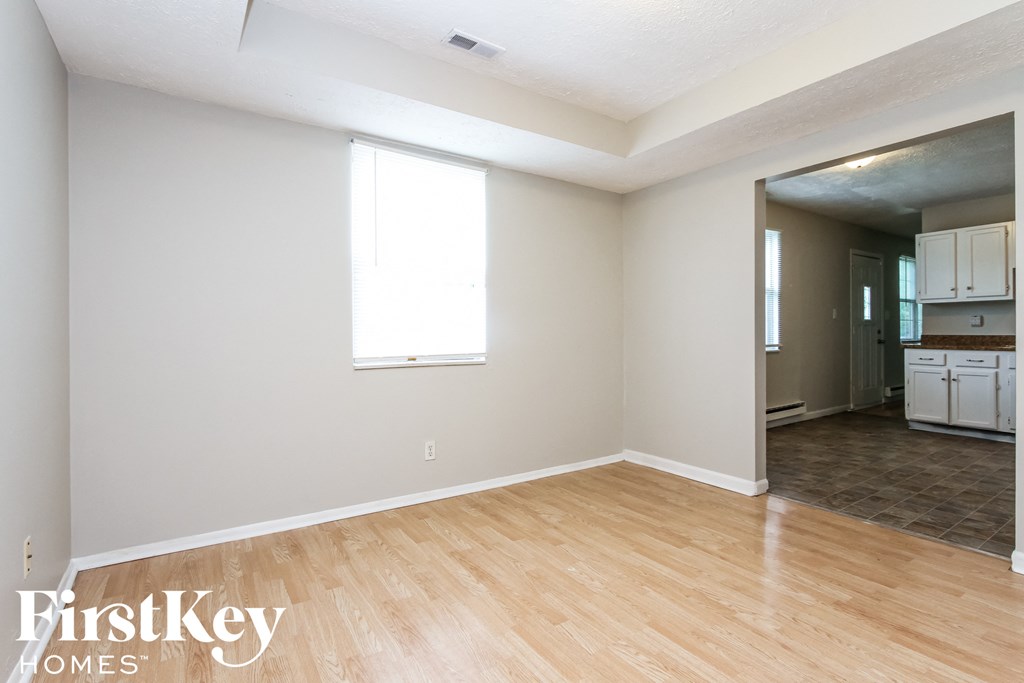 A room with wooden flooring and a window.